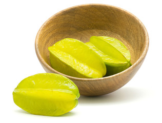 Fresh carambola in a wooden bowl isolated on white background.