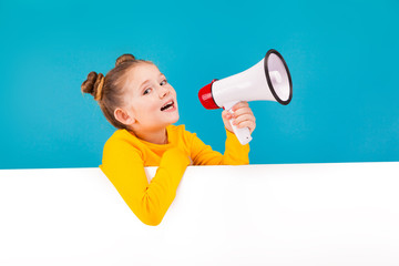 cute little girl in yellow pullover with the speaker