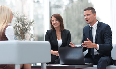 business team talking in office lobby