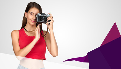 Young woman holding old fashioned camera