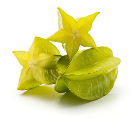 One whole carambola and one cut in half isolated on white background.