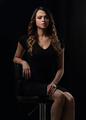 Fototapeta na wymiar young gorgeous caucasian brunette in dress on chair