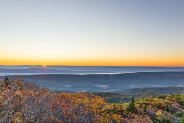 Obraz premium Morning dark sunrise with sky and golden yellow orange autumn foliage in Dolly Sods, Bear Rocks, West Virginia with overlook of mountain valley