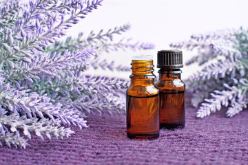 Bottles of essential lavender oil with flowers