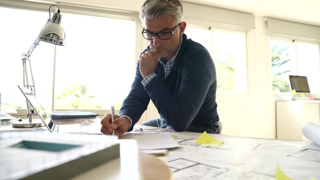 Architect in office working on construction project