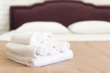 Fototapeta na wymiar Clean towels on bed at hotel room
