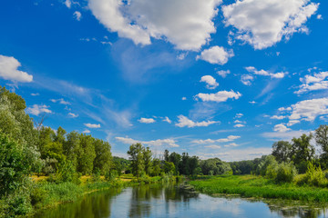 Clouds, blue sky, river - summer landscape.