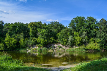 Fototapeta premium Summer day on the river, landscape, blue sky with clouds.