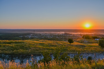 Fototapeta premium Sunset in the summer. Top view, orange sun.