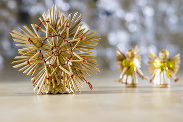 Christmas decorations for Christmas. Christmas ornaments made of straw. Decorations on a wooden table.