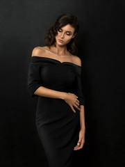 Young beautiful woman wearing black evening dress