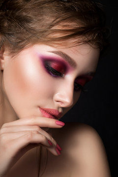 Closeup portrait of young beautiful woman with bright pink makeup