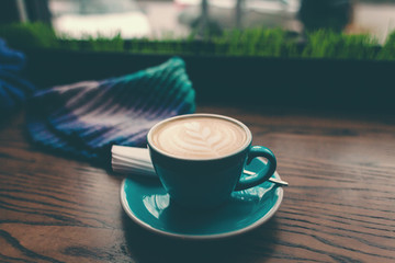 Cup of coffee on a wooden table.
