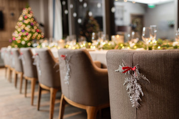 Christmas dinner feast. A decorated dining table with champagne glasses and christmas tree in background
