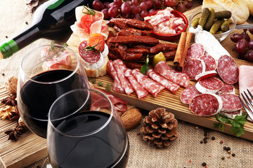 Food tray with delicious salami, pieces of sliced ham, sausage, tomatoes, salad and vegetable - Meat platter with selection - Cutting sausage and cured meat