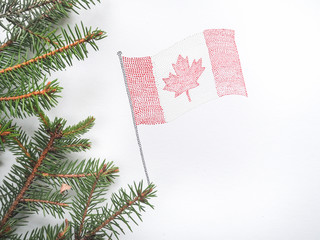 Canadian flag and the branches of the Christmas tree.
