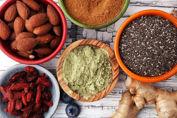 superfood concept with bowls in diffrent colors of various superfoods.