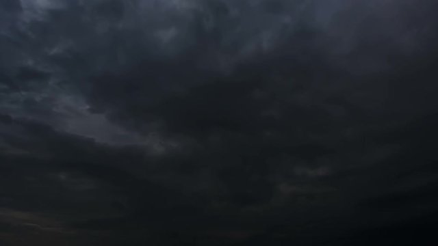 Thunderstorm clouds at night with lightning. 4K Timelapse Loop. Evening thunderstorm video landscape background. Impressive lightning storm sky. Several powerful flashes and lights.	