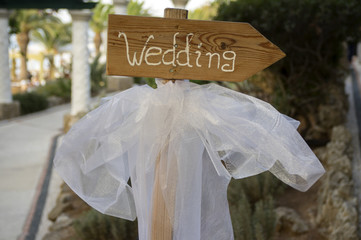 Wedding signpost arrow with white veil