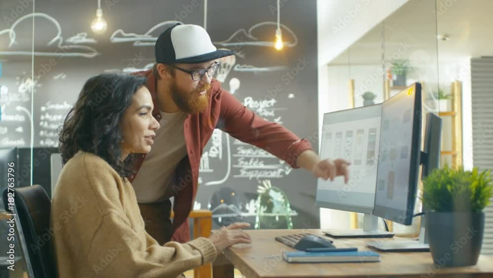 Poster At the Desk Beautiful Woman Developer Talks With Programer, Together They Design New Mobile Game/ Application. Shot on RED EPIC-W 8K Helium Cinema Camera.