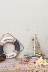 Copy space of set of lifebuoy, boat, starfish and flowers. Vacation on the sea.