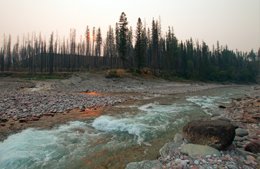 Sunset over the confluence of the South Fork of the Flathead River and Lost Jack Creek at Meadow Creek Gorge in the Bob Marshall Wilderness complex during the 2017 fall fires in Montana United States