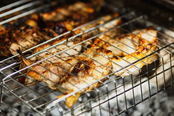fish steaks are roasted on the grill