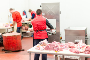 Butchers preparing fresh meat peaces for sale at market