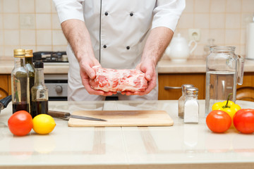 Man s hands holding beef piece, selective focus