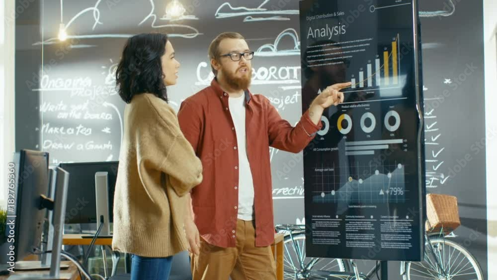 Aufkleber Female Developer and Male Statistician Use Interactive Whiteboard Presentation Touchcreen to Look at Charts, Graphs and Growth Statistics.  Shot on RED EPIC-W 8K Helium Cinema Camera.