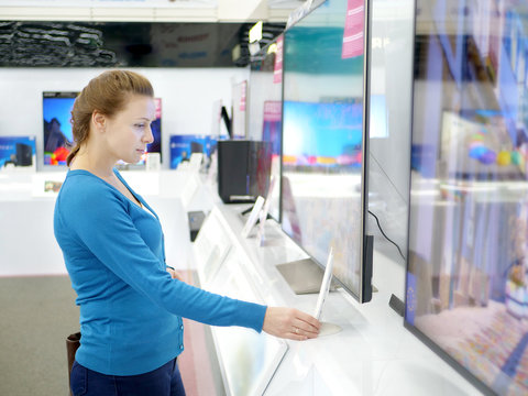 Woman buying TV in a store.