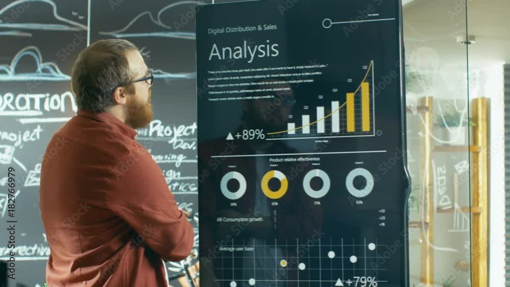 Poster marketer touches interactive whiteboard to look closer at the latest graphs and charts of statistica