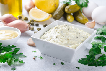 Traditional french sauce remoulade in a white bowl with ingredie