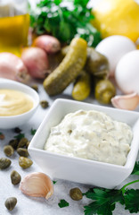 Traditional french sauce remoulade in a white bowl with ingredie