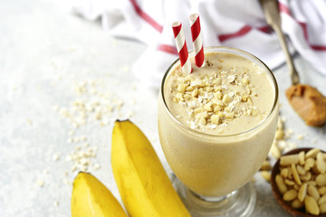 Banana peanut butter smoothie with oats and cinnamon in a glass.