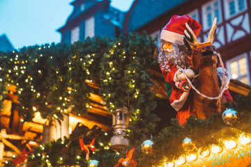 Christmas market spirit in Frankfurt, Germany. Celebrating xmas holidays. Lights, small houses at...