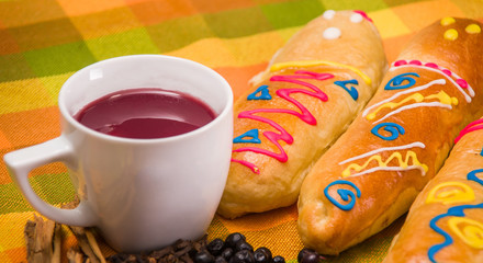 Close up of traditional Ecuadorian dish, colada morada and guaguas de pan, with assorted species to prepare, over a colorful fabrics