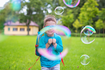 Young boy looking through a bubble smiling