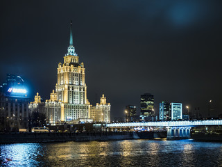 Fototapeta na wymiar night moscow signature architecture, river, lights, highway, traffic, streets, dark sky