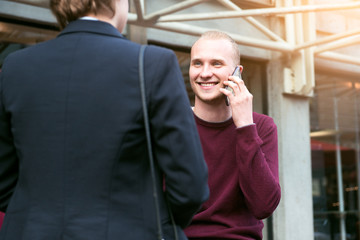 Young adult entrepreneurs people have business meeting talking on the street and making phone calls