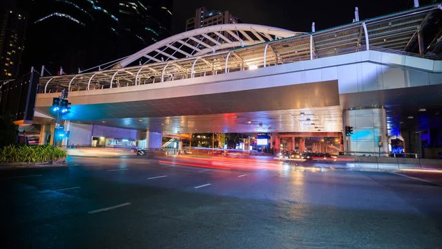 4k Time-lapse of public sky walk and traffic at Chong Nonsi sky train station at night, Bangkok, Thailand