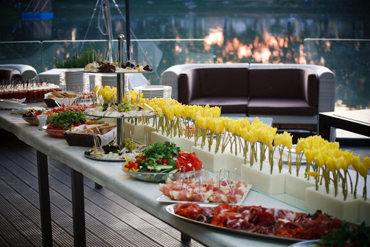 Buffet served table with snacks,fruits,canape,sweets and appetizers.Catering event plate service.Smorgasbord,food choice of breakfast in restaurant/Buffet line of lunch and dinner.Buffet self-service