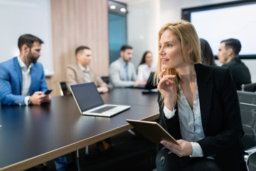 Elegant attractive businesswoman with tablet in office