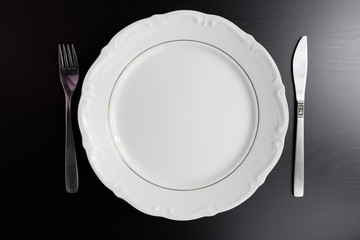 Top view empty white plate on black background