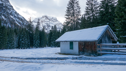 Cold winter scenery with chalet in the mountains