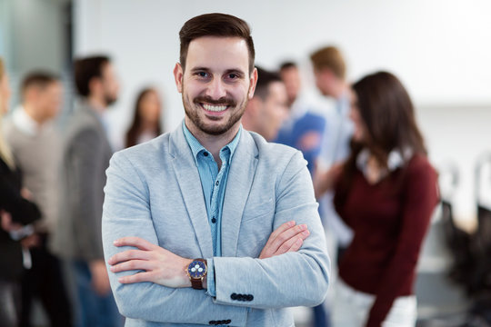 Group picture of businessman posing in office