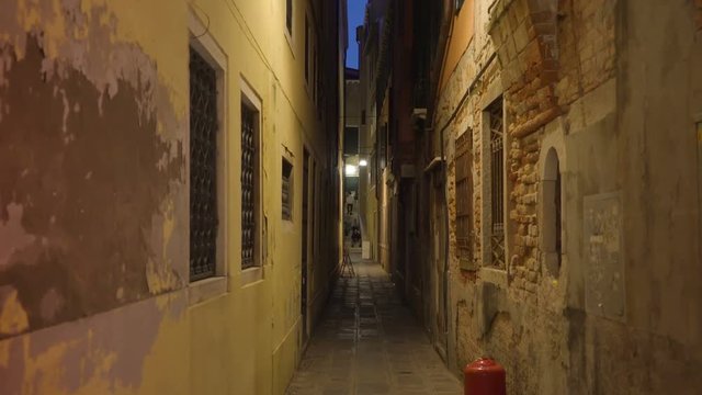 15062_A_narrow_street_in_the_middle_of_the_buildings_in_Venice_Italy.mov