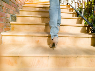 A business women in high hills is stepping on stair for successfu
