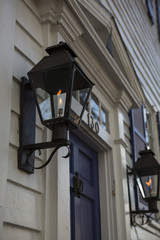 Fototapeta na wymiar Colonial townhouses, Closeup gas lights along a street
