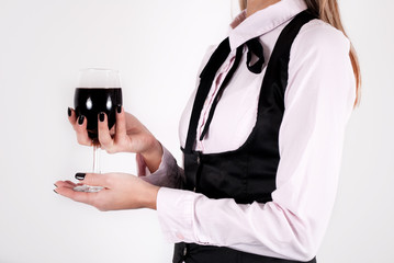 Young elegant girl holding red wine glass in hands isolated on white background. Close up